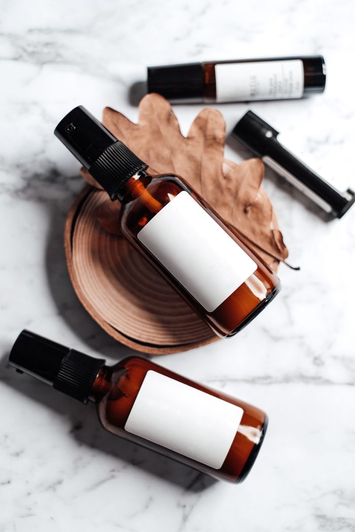 Stylish cosmetic product shot featuring bottles with labels on a marble surface.